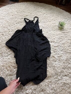 A chic black asymmetrical dress with flowing drape for an elegant silhouette. Li